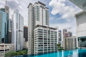 a view of a city skyline with a swimming pool at MyRehat Suites Bukit Ceylon in Kuala Lumpur