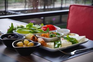 a tray filled with different types of food on a table at ReynaBe Boutique Hotel in Dikili +39 photos