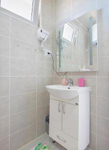 a bathroom with a sink and a mirror at APARTMAN OAZA in Pelinovo