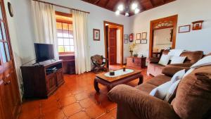 a living room with a couch and a tv at Manuela in Fuencaliente de la Palma