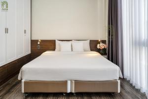 Postel nebo postele na pokoji v ubytování Nina Homes Phu My Hung + 37 fotografií