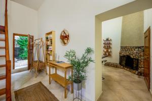 a living room with a table and a fireplace at Alchadef Park Apartment in Rhodes Town