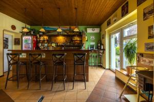 un bar en un restaurante con taburetes en una habitación en Penzion Rodos - Café, en Praga