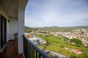 a balcony with a view of a city at Lino's Family Guesthouse in Peso da Régua