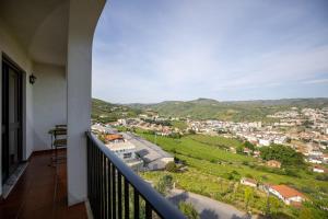 a balcony with a view of a city at Lino's Family in Peso da Régua