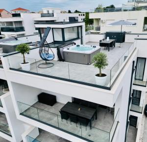 a balcony with a hot tub on top of a building at Penthouse Maus in Trogir