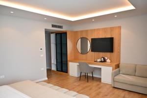 a hotel room with a desk and a television at Hotel Zanzi in Durrës