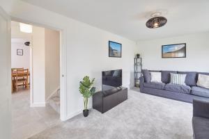 a living room with a couch and a table at Host & Stay - Cayton Bay Cottage in Cayton