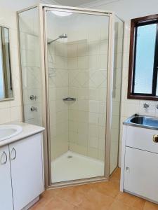 a bathroom with a shower and a sink at BIG4 Taunton Farm in Cowaramup