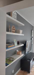 a room with a desk and shelves with books at Apartament Rodzinny Przy AquaParku in Reda