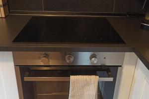 an oven with a towel on the front of it at Casa Anna Big House Near Lake Garda and Centre in Salò