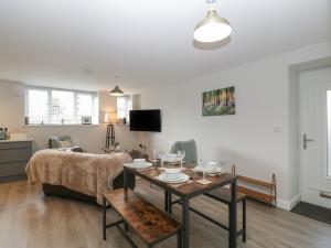 a living room with a table and a couch at The Old School in Cinderford