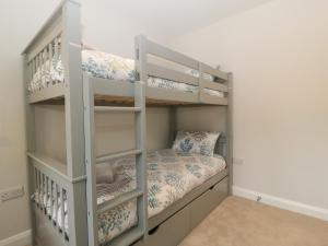 a bunk bed in a small room with a bunk bed in a room at The Old School in Cinderford