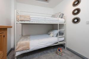 a bedroom with two bunk beds with a teddy bear at Hoopers Lodge, Croft Hooper, Crowlas in Ludgvan