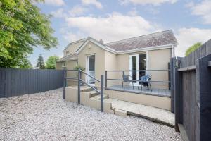 a small house with a fence and a patio at Hoopers Lodge, Croft Hooper, Crowlas in Ludgvan