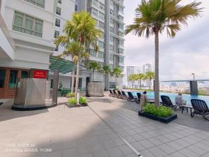 a courtyard with benches and palm trees in a building at Peace home09 in Cyberjaya