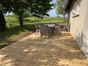 un patio con sillas y una mesa en una acera en Le Petit Saule - Gîte entre Beauval et Chenonceau, en Faverolles-sur-Cher