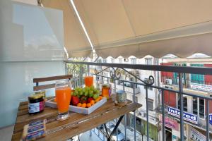 a table with fruit and drinks on a balcony at Saroko Suite in Corfu Town