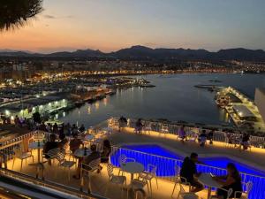 a view of a marina at night with people sitting at tables at 2 bedroom infinity beach. in Mazarrón