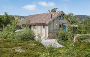 a house with a tin roof on a hill at Stunning Home In Edland With House A Mountain View in Vågsli