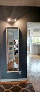 a room with a door and a mirror in a room at Apartament Rodzinny Przy AquaParku in Reda