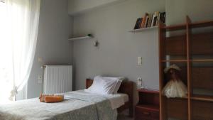 a bedroom with two beds and a book shelf at Corinas Holiday House in Chania