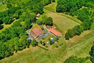an aerial view of a house in a field at Le Domaine De Dolly in Villeneuve-sur-Lot