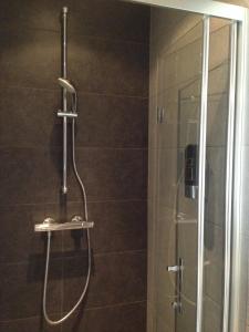 a shower with a glass door in a bathroom at B&B House No 7 in Amsterdam +17 photos