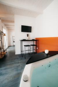 a living room with a swimming pool and a table at Le canne Pool and Relax in Pulsano