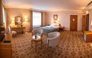 a hotel room with a bed and a table and chairs at Continental Hotel in Ulaanbaatar