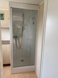 a shower in a bathroom with a glass door at Le bonheur est dans le pré. in Le Tréport
