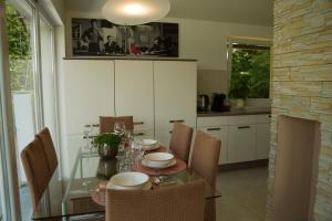 a dining room with a glass table and chairs at Sofia Holiday Haven in Nature with Pool in Slovenska Bistrica