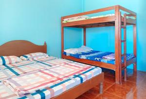 two bunk beds in a room with blue walls at Sunset Beach and Family Resort Gonzaga Cagayan in Bawa