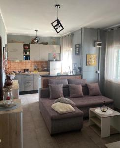 a living room with a couch and a kitchen at Island paradise Lavdara in Sali +14 photos