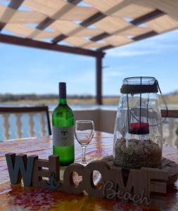 a table with a bottle of wine and a glass at Island paradise Lavdara in Sali