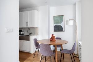 a dining room table and chairs in a kitchen at Midtown East 2br w gym wd nr Grand Central NYC-1146 in New York
