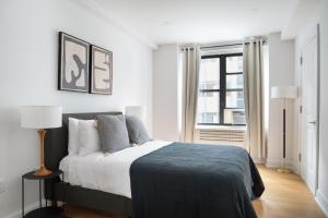 a bedroom with a bed and a window at Midtown East 2br w gym wd nr Grand Central NYC-1146 in New York