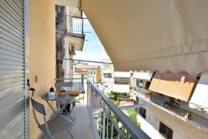 a balcony with a table and a view of a city at Saroko Studio in Corfu