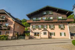 a large building with windows and balconies on it at Hotel-Pension Falkensteiner in Sankt Gilgen