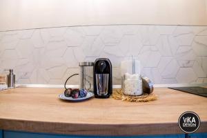 a counter top with a coffee maker and a plate of food at Bulevard Apartments 11 in Alba Iulia