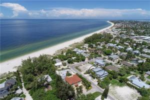 an aerial view of a beach with houses and the ocean at Footprints in the Sand managed by Beach Retreats in Holmes Beach