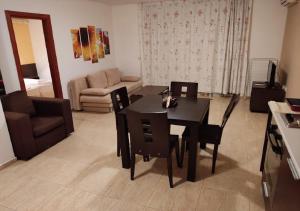 a living room with a black table and chairs at Kims One-bed Apart for rent at Sunny Beach Resort in Sunny Beach