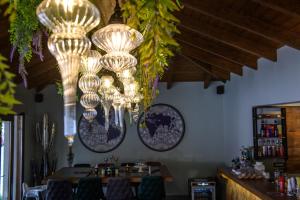 a dining room with chandeliers hanging from the ceiling at Álbero Hotel in Pérama