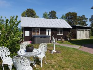 a table and chairs in front of a house at Drag 171 Villa Sjödal in Drag