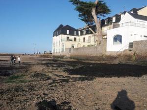 a shadow of a person standing in front of a building at Tous à l'ouest in Combrit