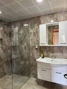 a bathroom with a sink and a shower at Kekova Pansiyon in Demre