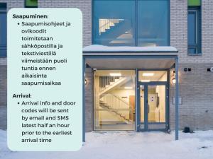 a sign in front of a building with an open door at Hiisi Homes Järvenpää in Järvenpää
