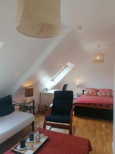 a living room with a bed and a couch at Tous à l'ouest in Combrit