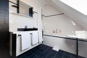 a white bathroom with a sink and a toilet at Tous à l'ouest in Combrit
