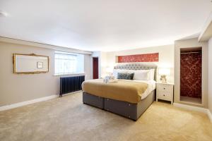 a bedroom with a large bed and a large window at The Governance Apartments in Windermere
